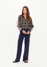 THE UPSIDE women’s navy organic cotton Cosmo Kairo Half Zip Knit is a relaxed fit and features a half zip front and beige knitted stripes down sleeves. Made for everyday leisure.