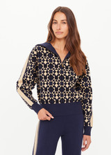 THE UPSIDE women’s navy organic cotton Cosmo Kairo Half Zip Knit is a relaxed fit and features a half zip front and beige knitted stripes down sleeves. Made for everyday leisure.
