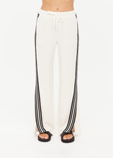 THE UPSIDE women’s cream Roma Pant is a true-to-size fit and features an elasticated waistband with drawcord, pockets and black and cream contrast stripes down sides. Perfect for everyday.