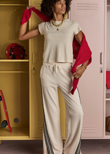 THE UPSIDE women’s cream Roma Pant is a true-to-size fit and features an elasticated waistband with drawcord, pockets and black and cream contrast stripes down sides. Perfect for everyday.