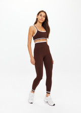 THE UPSIDE women's brown Form Seamless 25in Midi Pant is designed for a firm & supportive fit and features contrast white stripes on waist and ankles. Made for yoga & pilates.