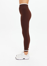 THE UPSIDE women's brown Form Seamless 25in Midi Pant is designed for a firm & supportive fit and features contrast white stripes on waist and ankles. Made for yoga & pilates.