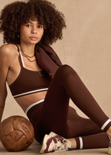 THE UPSIDE women's brown Form Seamless 25in Midi Pant is designed for a firm & supportive fit and features contrast white stripes on waist and ankles. Made for yoga & pilates.