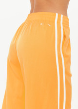 THE UPSIDE women’s lightweight yellow Juliet Pant features a low-rise fit with contrast binds and split hem detail. Perfect for travel and everyday wear.