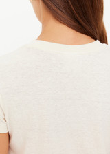 THE UPSIDE women's creme organic cotton The 70's Tee features a rib neckline and classic 70s-inspired style. Made for everyday wear.