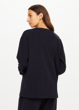 THE UPSIDE women's black recycled cotton Soho Cara Long Sleeve Top is designed for a relaxed fit and features a ribbed neck and cuffs and a patch pocket at front. Made for everyday leisure.