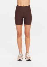THE UPSIDE women's brown high-waisted Peached 5inch Spin Short offers a soft & supportive fit in recycled peached fabric and features a printed arrow logo on back waistband. Made for pilates & yoga.