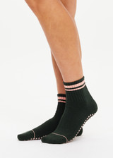 THE UPSIDE women's green Tamara Grip Sock features a soft terry sole, mid ankle height and pink stripe details. Made for yoga & pilates.