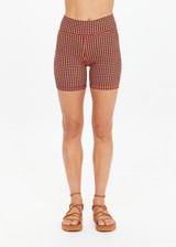 THE UPSIDE women's orange & navy check Solaris 5inch Spin Short is mid-rise and features an embroidered arrow logo at back. Made for yoga & pilates.