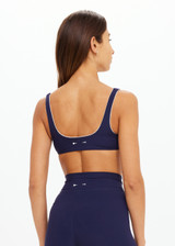 THE UPSIDE women's navy recycled peached Maison Rory Scoop Bra features a scooped square neckline and removable cups. Made for yoga & pilates.