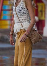 THE UPSIDE women's natural organic cotton Kamali Knit Fringe Top has a loose, boxy fit with scooped low back and knitted fringe detailing at hem. Made for lifestyle.