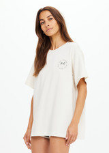 THE UPSIDE women's cream organic cotton Molokai Sammi Tee offers a oversized fit and features a green printed palm logo on front chest and back. Made for lifestyle.
