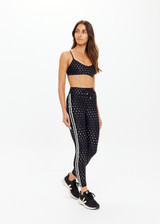 THE UPSIDE women's black Moonstone 25inch Legging has a soft, supportive fit with elastic drawcord, cream aglet ends, and contrast cream side bindings. Made for yoga & pilates.