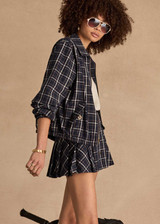 THE UPSIDE women's check Valencia Jones Pleated Skirt is true to size with structured waistband, belt loops, and antique brass button closure at centre front. Made for lifestyle.