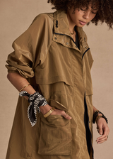 THE UPSIDE women's brown Rylan Anorak is relaxed fit, mid-length, made from tan wrinkled water-resistant fabric. Made for yoga & pilates.