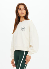 THE UPSIDE women's natural Molokai Paloma Crew is boxy fit with an embroidered green palm tree logo at front chest. Made for lifestyle.