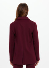 THE UPSIDE women's maroon Mendoza Boyfriend Blazer is designed as a boyfriend style single breasted blazer with cream piping along side seams, tortoiseshell buttons and front welt pockets.