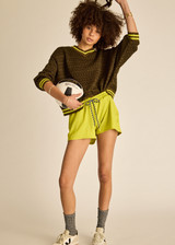 THE UPSIDE women's olive organic cotton Castilla Clementine Knit Crew is designed for a relaxed fit and features a high V neckline with lime-striped rib. Made for lifestyle.