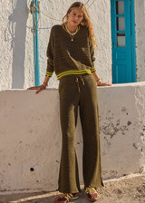 THE UPSIDE women's olive organic cotton Castilla Juniper Knit Pant has a soft and supportive fit and features a straight leg with contrast side stripes. Made for lifestyle.