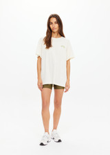 THE UPSIDE women's natural organic cotton Isadora Sammi Tee is designed for an oversized fit and features a printed logo in lime and blue with a soft rib neckline. Made for lifestyle.