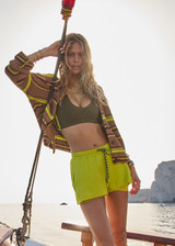 THE UPSIDE women's green recycled polyester Lucky Run Short is designed for a true-to-size fit and features a slightly curved hem with inner short for full coverage. Made for running.