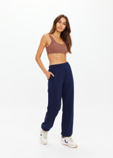 THE UPSIDE women's navy organic cotton Harrison Trackpant offers a relaxed fit and features an elasticated waistband with side pockets. Perfect for everyday comfort.