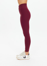 THE UPSIDE women's maroon recycled peached 25 Inch Midi Pant is designed for a soft and supportive fit and features a mid-rise and moisture-wicking. Made for yoga and pilates.