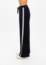THE UPSIDE women's navy polka dot Spellbound Roma Pant is true to size and features metallic silver spots on velvet fabrication and side seam pockets. Made for lifestyle.