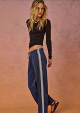 THE UPSIDE women's navy Galaxia Loretta Pant is designed for a mid to low rise fit and features elasticated waistband, drawcord with side seam pockets and knitted tape down sides. Made for lifestyle.