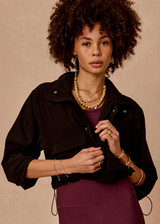 THE UPSIDE women's black Ace Shell Jacket is a water-resistant cropped zip-through jacket and features front pockets and an adjustable drawcord at waist. Made for running.