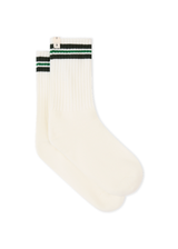 THE UPSIDE women's cream Courtship Crew Sock features green jacquard stripes and cream arrow logo at edge.
