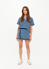 THE UPSIDE women's navy and blue plaid cotton Clubhouse Reece Mini Skirt is designed as a faux wrap skirt featuring a soft elastic waistband and a curved hemline. Made for tennis, golf & pickleball.