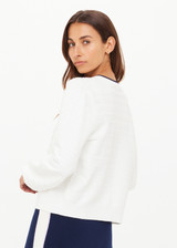 THE UPSIDE women's cream Jolie Isabeli Knit Cardigan is a regular fit with a blouson sleeve crafted from a pointelle knit and features navy embroidered bows. Made for tennis, golf & pickleball.