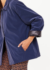 THE UPSIDE women's navy Levi Reversible Quilted Jacket is designed for a relaxed fit and features welt pockets, magnectic snap closure and a water resistant coating on black quilting. The perfect outerwear piece.