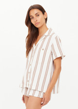 THE UPSIDE women's mocha stripe organic cotton Baja Katia Collared Shirt offers a relaxed fit and features a collar, patch pockets and wooden coconut buttons. Made for lifestyle.