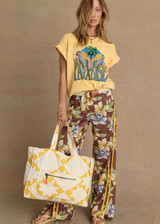 THE UPSIDE women's yellow organic cotton Paradise Jacob Tee is designed for an oversized fit and features a printed Paradise graphic on front. Made for everyday.