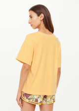 THE UPSIDE women's yellow organic cotton Paradise Jacob Tee is designed for an oversized fit and features a printed Paradise graphic on front. Made for everyday.