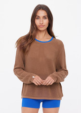 THE UPSIDE women's brown organic cotton Avalon Bayli Knit Crew is a crew neck sweater with drop shoulders in brown, a ribbed neckline in contrast blue and open knit construction. Made for lifestyle.