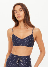 THE UPSIDE women's blue Bellaire Ballet Sports Bra features a cream star print and offers soft support and low coverage, designed with adjustable straps and a supersoft recycled fabrication. Made for yoga & pilates.