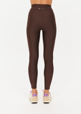 THE UPSIDE women's brown eco tech Oxford 25Inch Legging offers a mid rise with lilac coloured binds down side seams and an elastic drawcord through waist. Made for high impact.