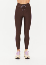 THE UPSIDE women's brown eco tech Oxford 25Inch Legging offers a mid rise with lilac coloured binds down side seams and an elastic drawcord through waist. Made for high impact.