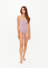 THE UPSIDE women's stripe jacquard Miami Flow Scoop One Piece features adjustable elastic straps with a scoop neckline in a striped lilac and chocolate design. Made for swim.