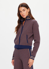 THE UPSIDE women's brown organic cotton Lumiere Margot Knit Jacket is a knitted long sleeve with a geometric star pattern, front pockets and contrast stripes around the sleeves. Made for lifestyle.