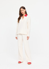 THE UPSIDE women's cream cotton Noosa Calling Collared Top is a relaxed long sleeve top in a soft brushed recycled fabrication with contrast red at the neck. Made for lifestyle.