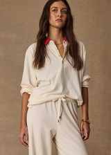THE UPSIDE women's cream cotton Noosa Calling Collared Top is a relaxed long sleeve top in a soft brushed recycled fabrication with contrast red at the neck. Made for lifestyle.