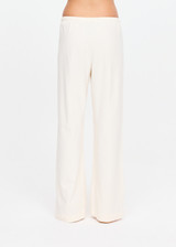 THE UPSIDE women's cream cotton Noosa Calling Track Pant is a low-rise straight leg pant with a soft elastic waistband, made from soft brushed recycled fabric. Made for lifestyle.