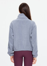 THE UPSIDE women’s grey recycled Sol Fleece Jacket has a relaxed fit with elastic waist and arm cuffs with polar fleece fabrication in marle. Made for lifestyle.