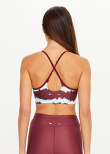 THE UPSIDE women’s tie dye recycled Rio Badu Crossback Sports Bra is a soft and supportive and features a scooped neckline, crossback straps and removable cups. Made for yoga and pilates.