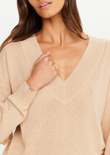 THE UPSIDE women’s sand linen organic cotton Bonita V Neck Knit is designed for a regular fit and features a wide neckline, dropped shoulders and ribbed trims. Made for lifestyle.