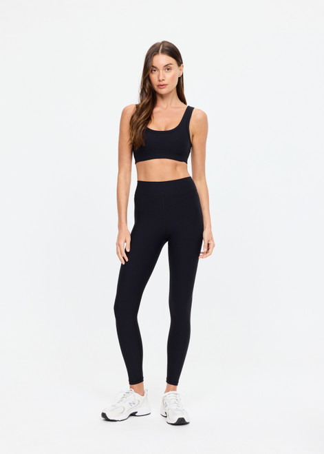 THE UPSIDE women's black Peached 25in Midi Pant is a mid-rise 7/8 length legwear made from recycled soft peached fabric with breathable and moisture-wicking fabrics.